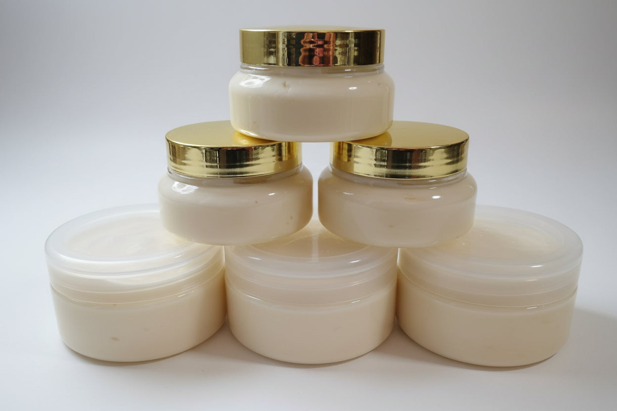 Set of white jars with gold lids on a wooden surface