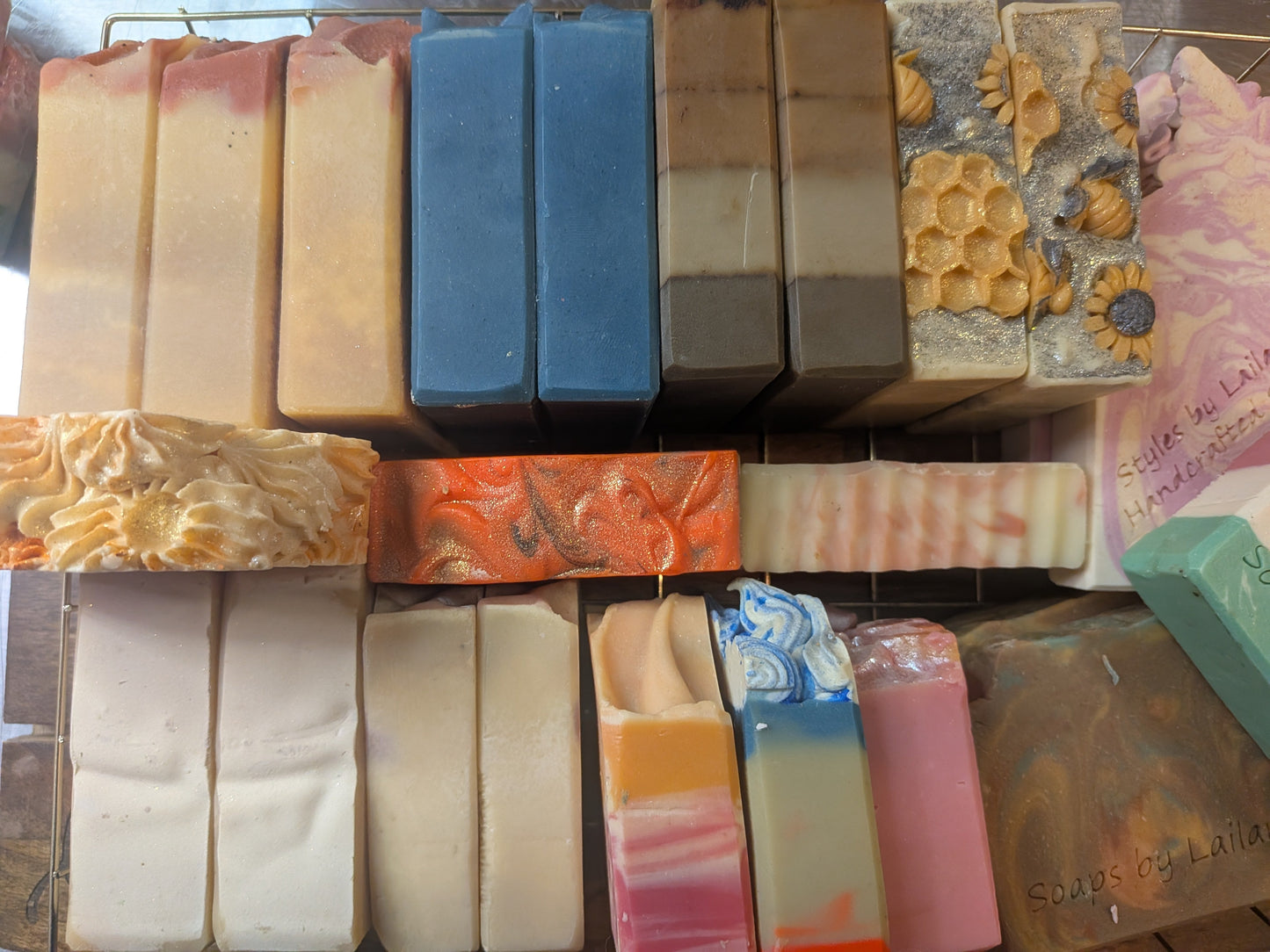 Stack of variously colored and textured soap bars on a display stand.
