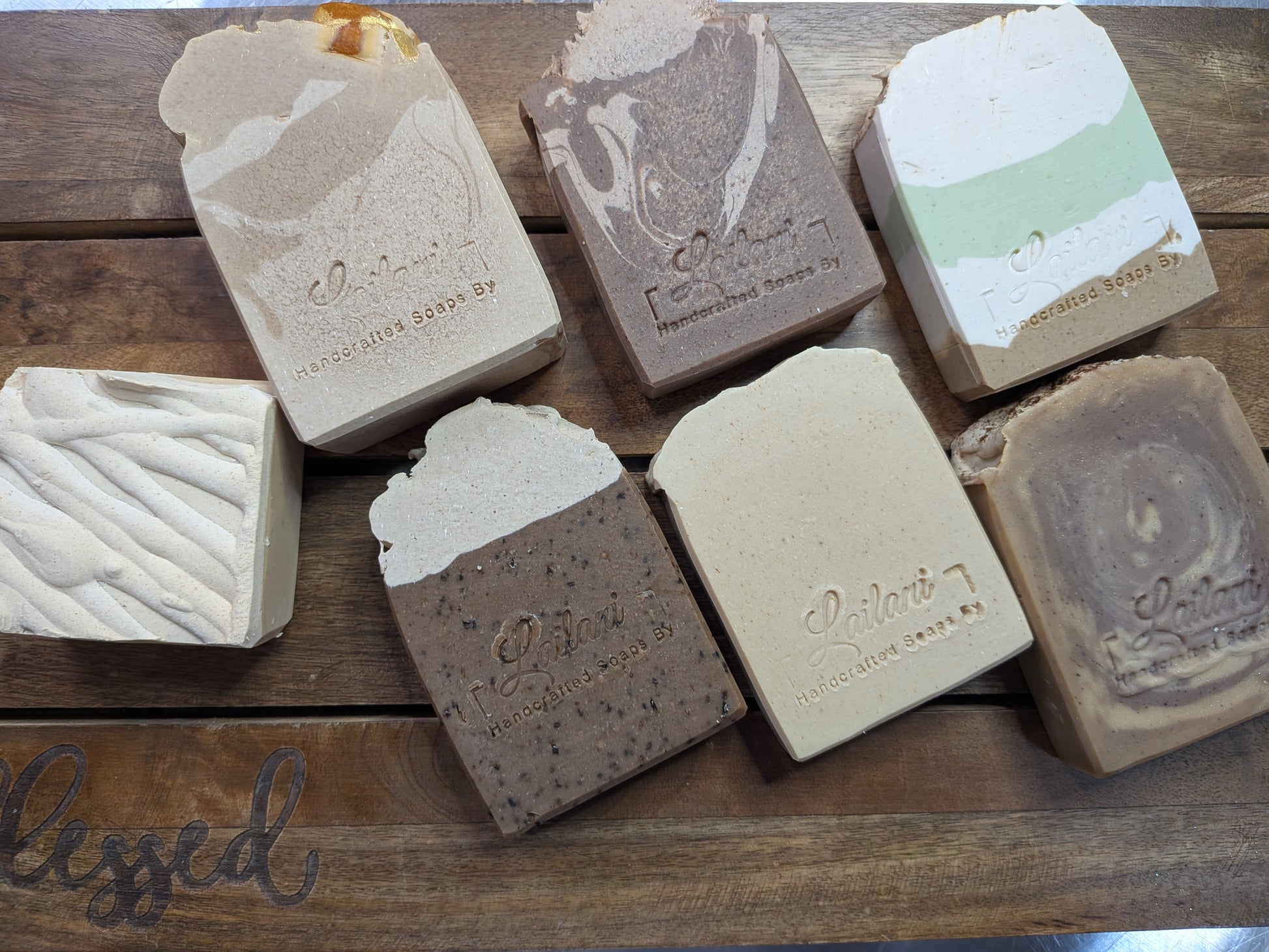 Assorted bars of soap on a wooden surface