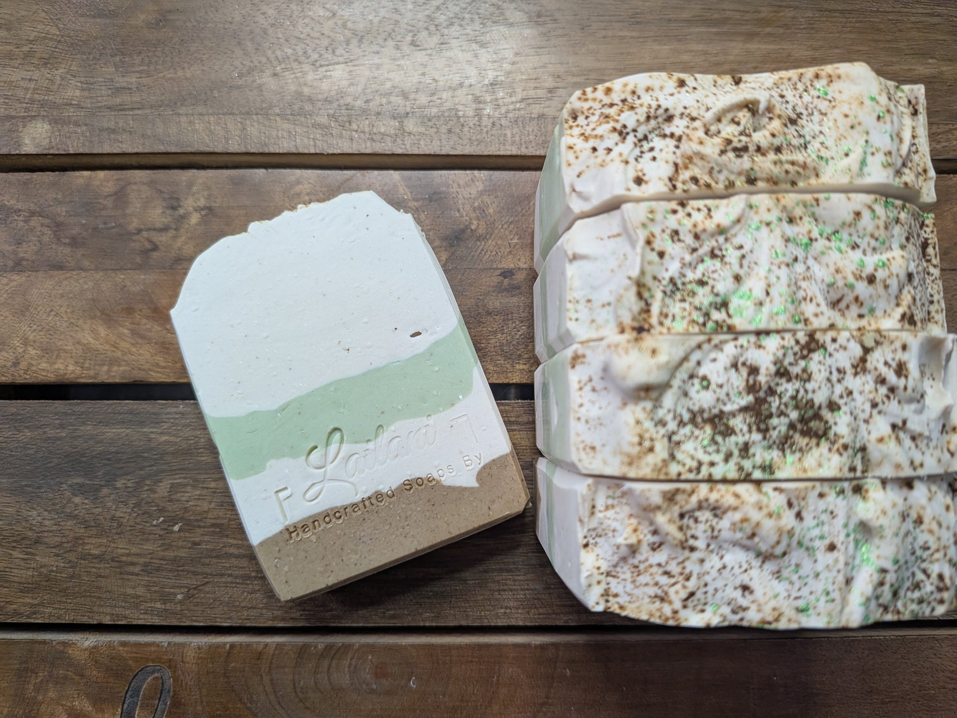 Bar of soap with a visible brand logo on a wooden surface