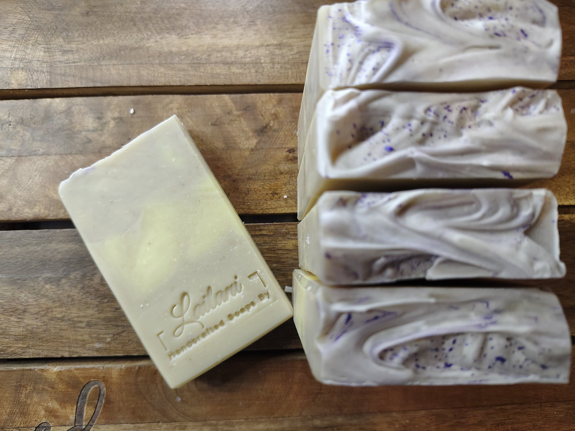 Bar of soap with 'Lailani' branding on a wooden surface